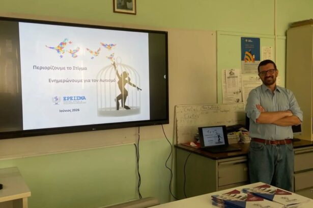 Presenter in a classroom giving a talk about reducing stigma and autism awareness (June 2026) with a large screen showing butterflies and a cage image.